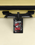 Black luggage tag with red and white graffiti text did you see my bag, crown and microphone design, BTS Mic Drop inspired, attached to a suitcase handle"