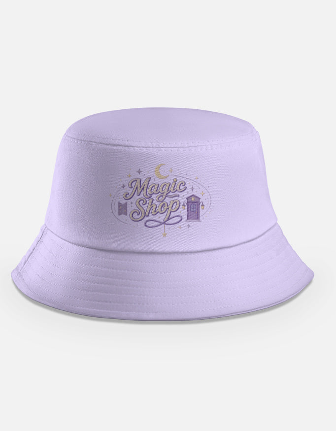 "Lavender bucket hat with Magic Shop design showing a purple door, crescent moon and stars, inspired by the BTS song Magic Shop"